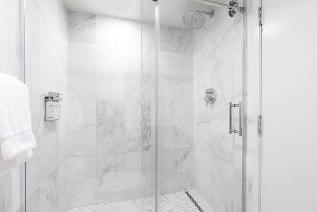 Large glass-enclosed shower. 