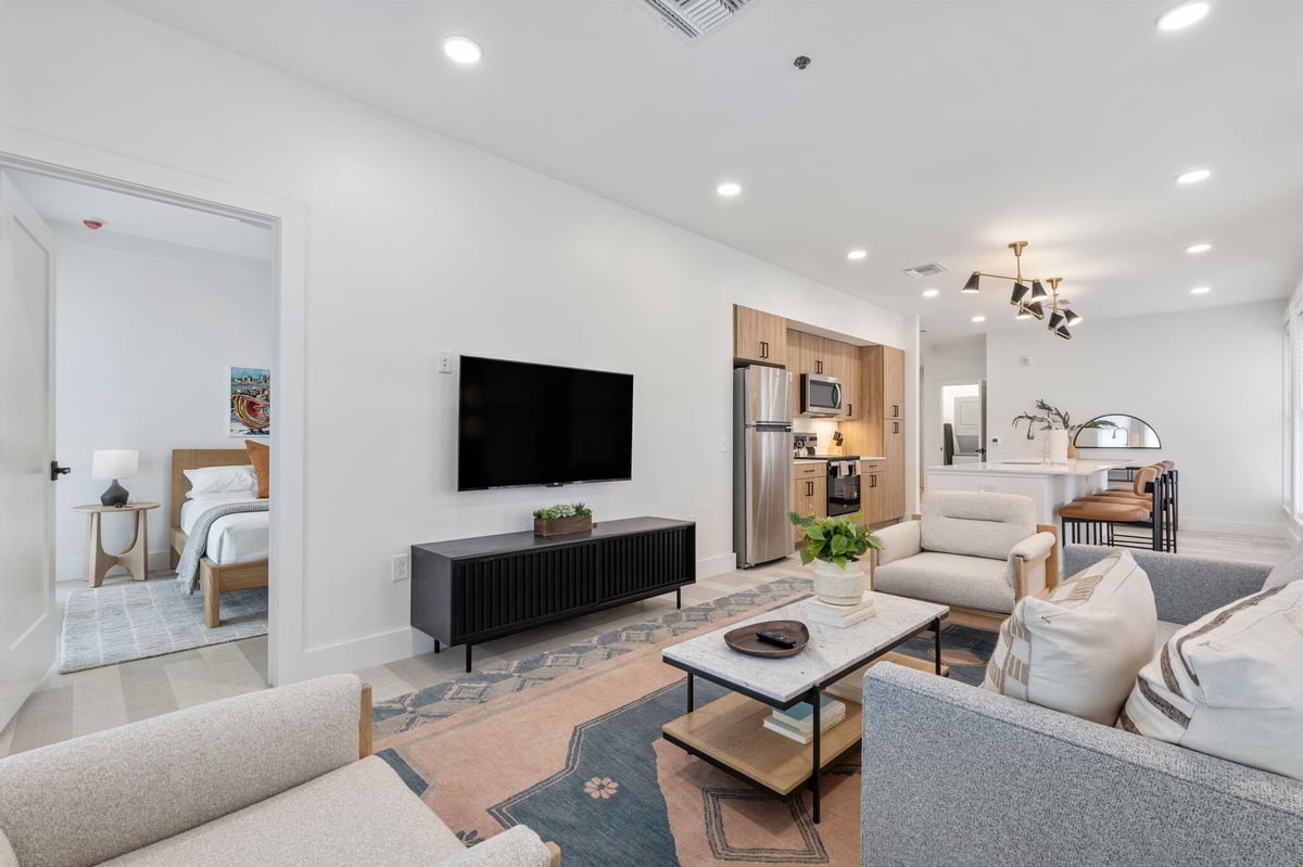 Living area, kitchen, and bedroom