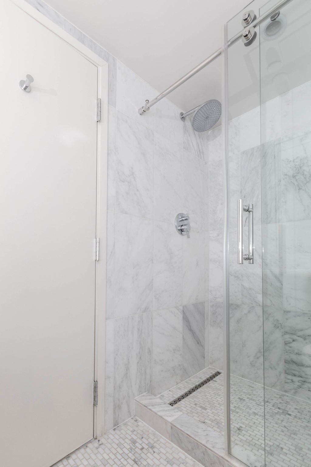 Walk-in, glass-enclosed shower.
