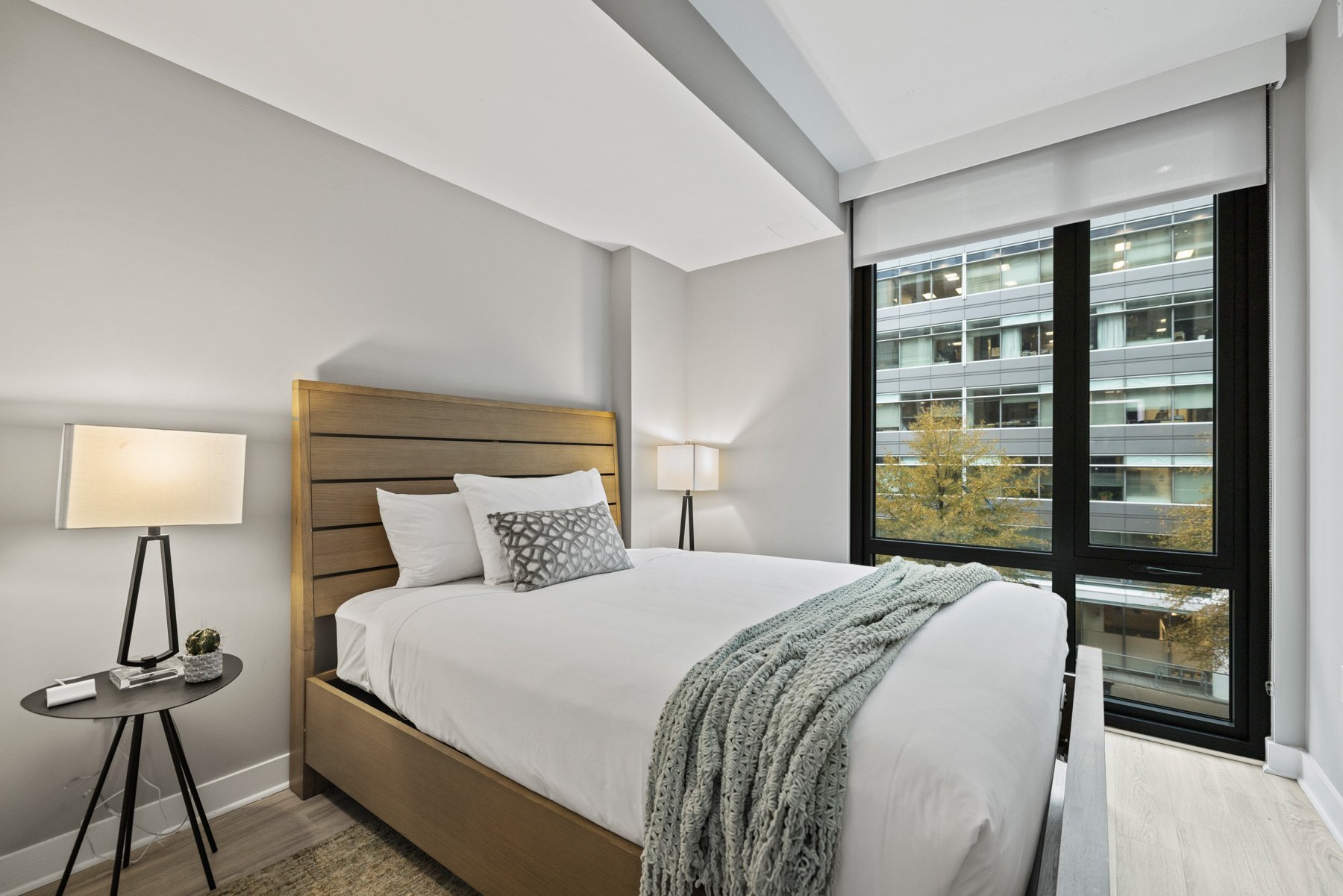 Modern bedroom with large windows 