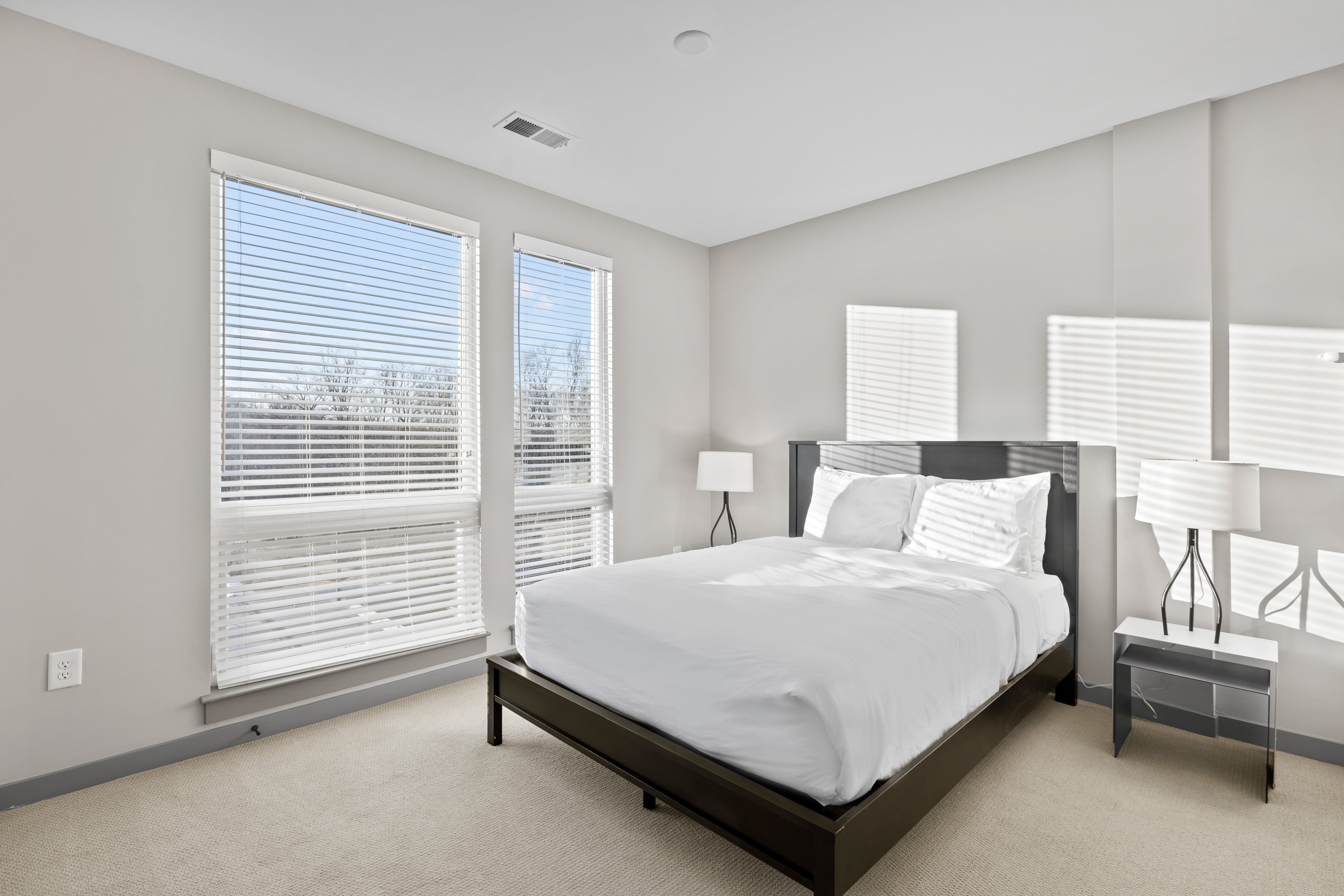 Bedroom with queen bed and natural light. 