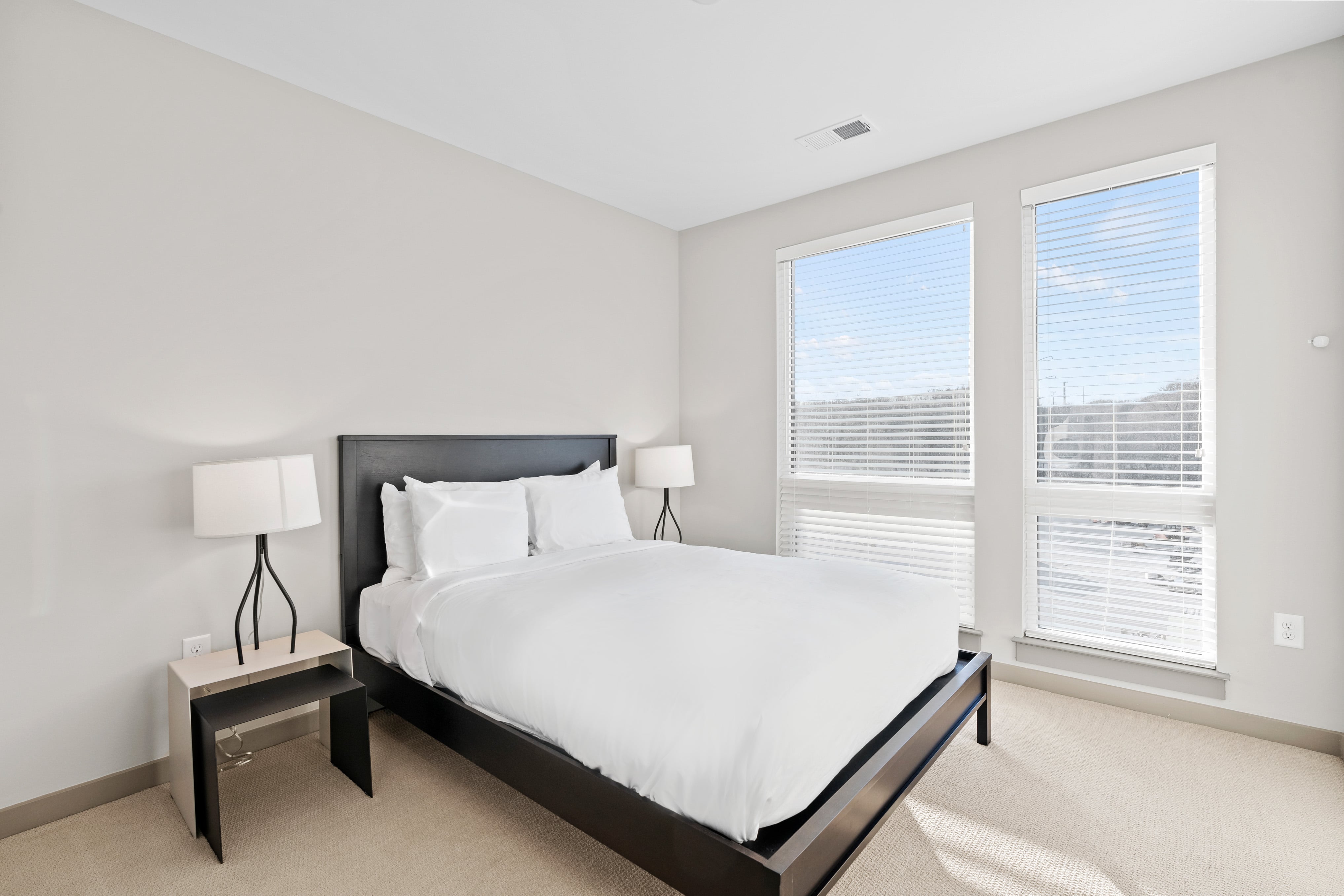 Bedroom with queen bed and natural light. 