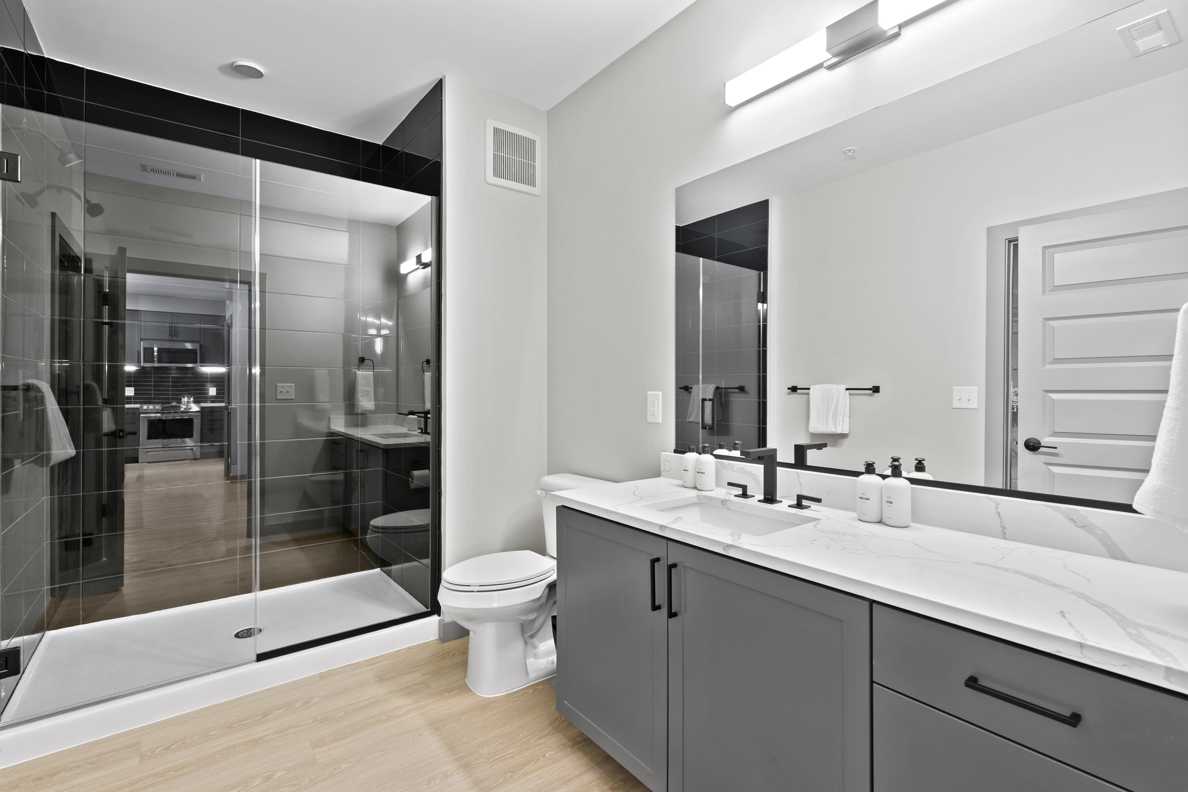 Modern bathroom with shower and double sinks. 