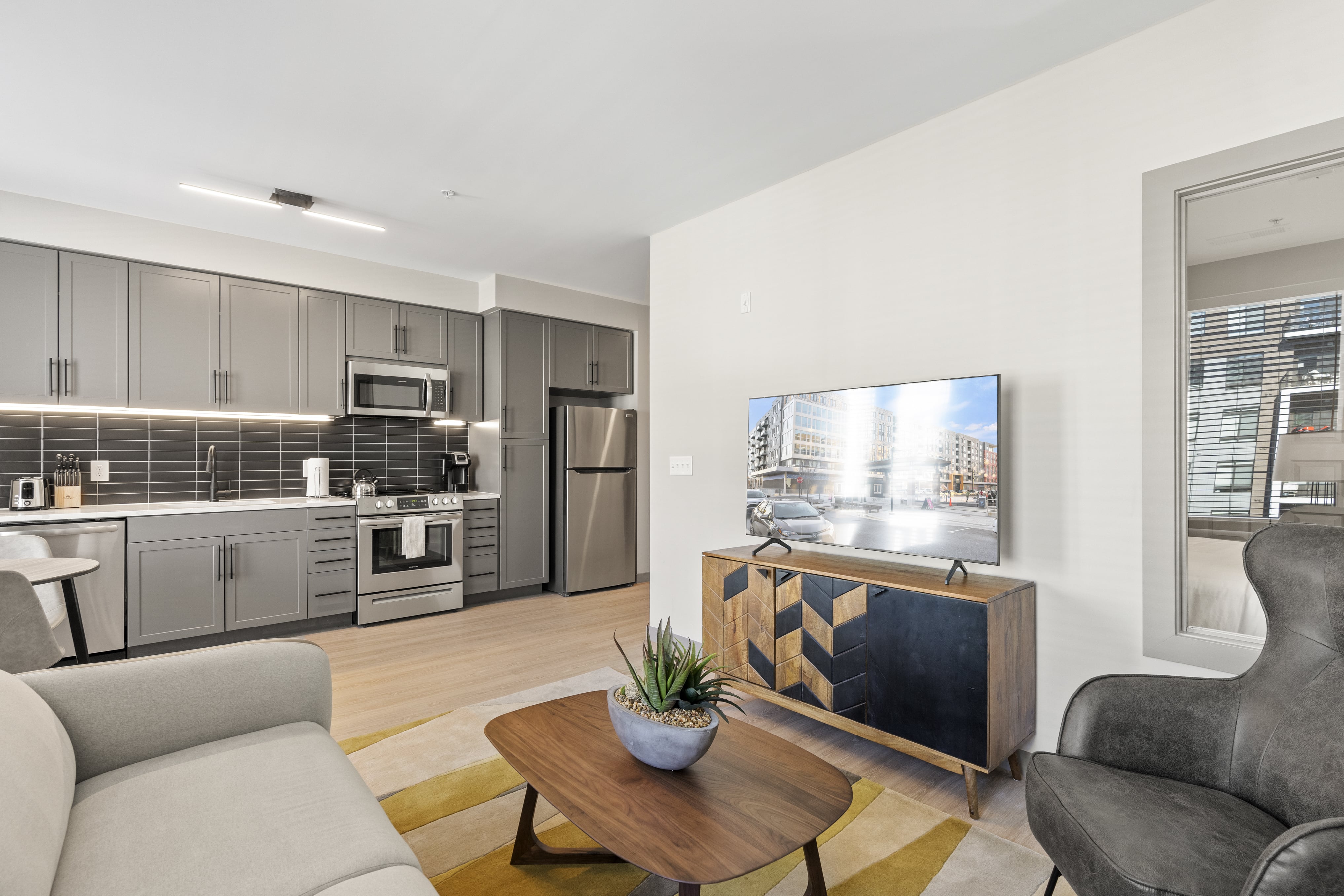 Kitchen and living space with television. 