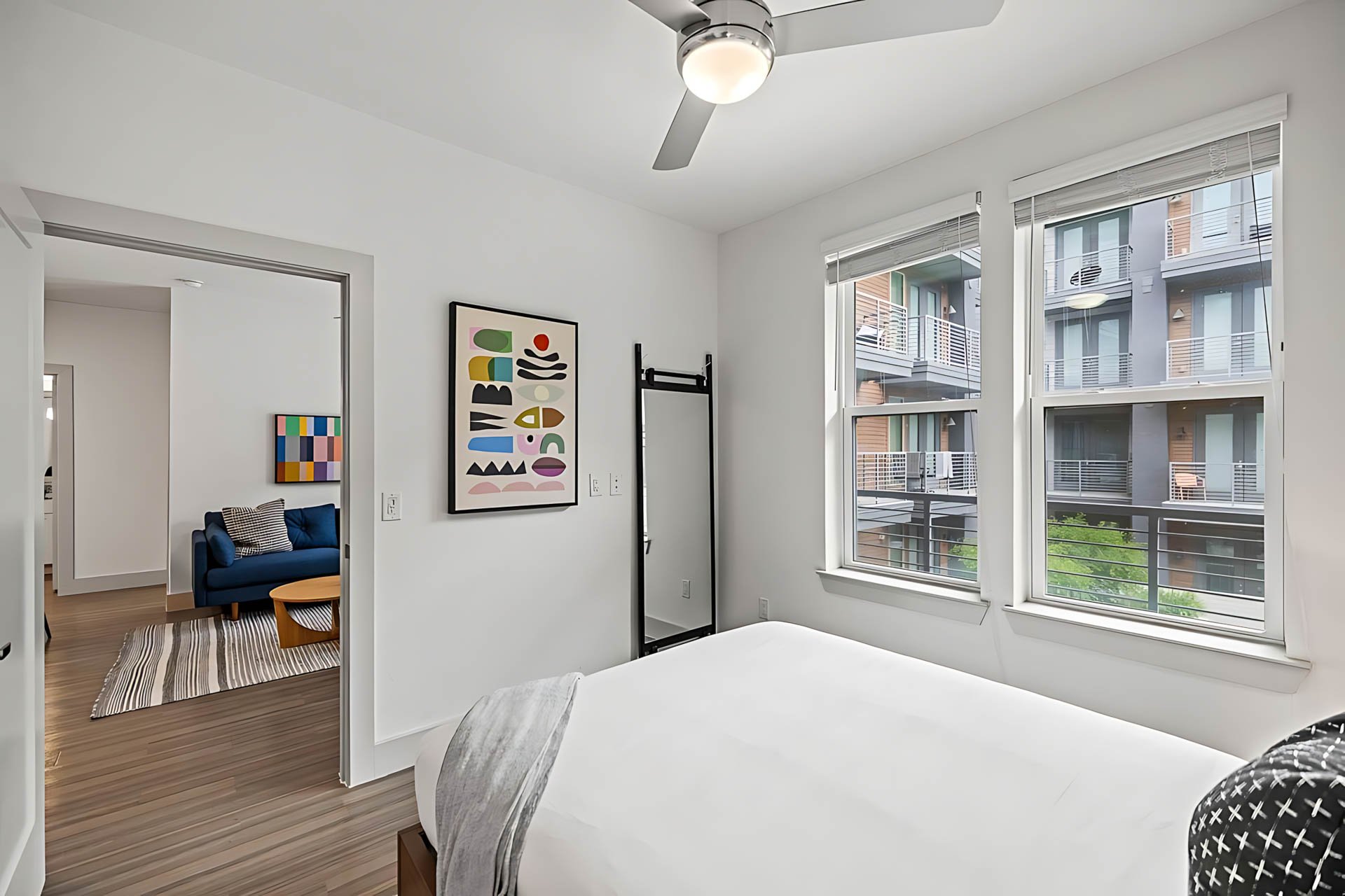 AUTX002_Guestroom_Premium Two Bedroom Apartment_Bed_White bed gray throw