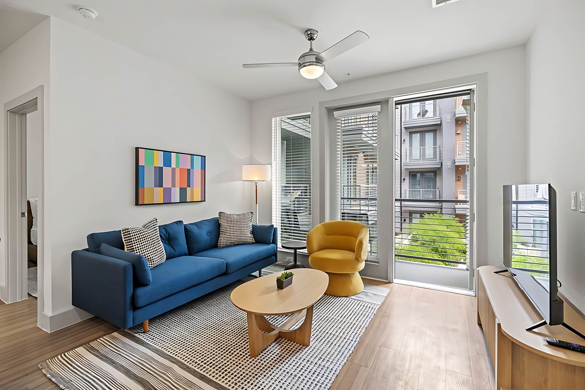 AUTX002_Guestroom_Premium Two Bedroom Apartment_Lounge Area_Yellow Swivel Chair Setup