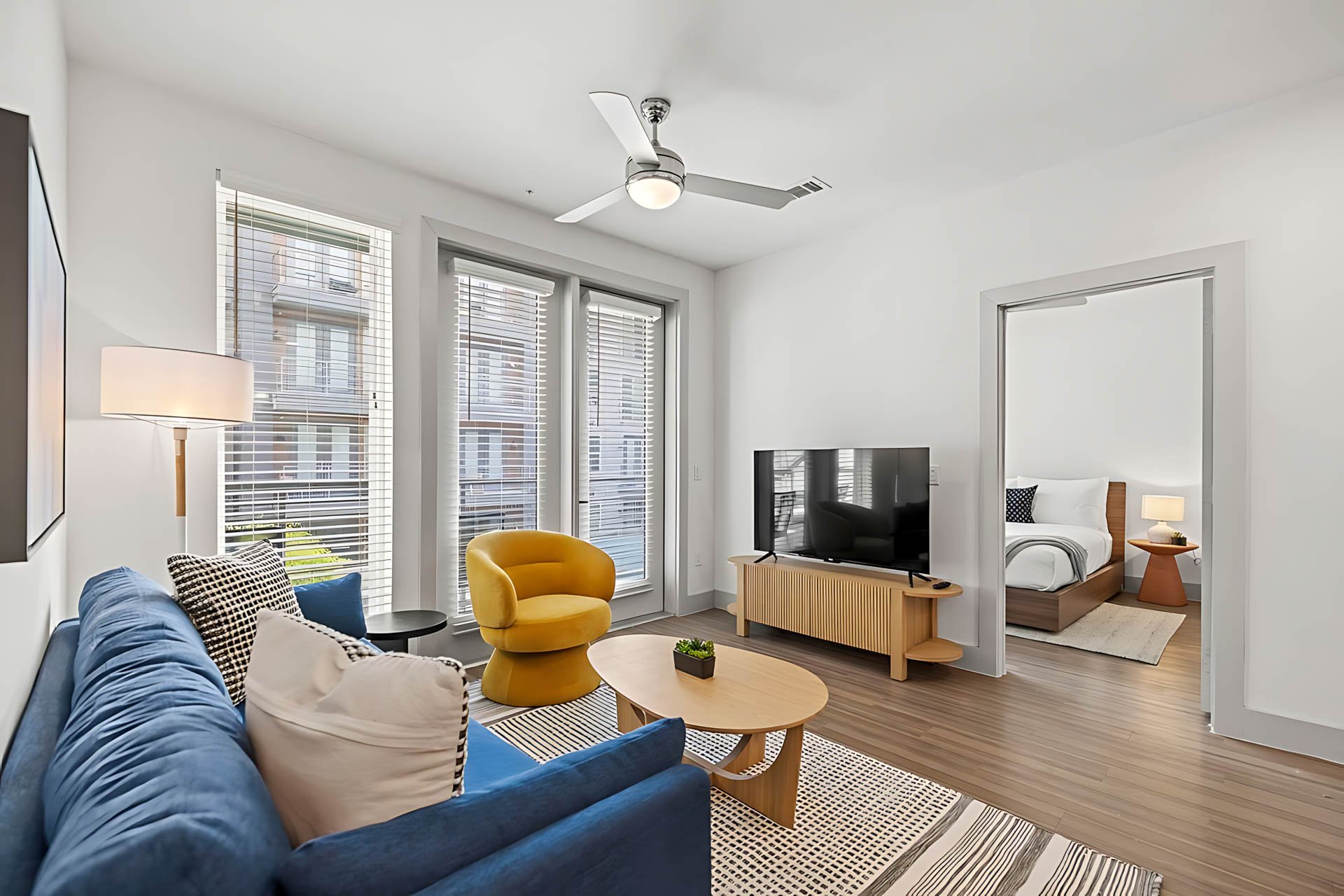 AUTX002_Guestroom_Premium Two Bedroom Apartment_Lounge Area_Yellow Chair Bedroom View