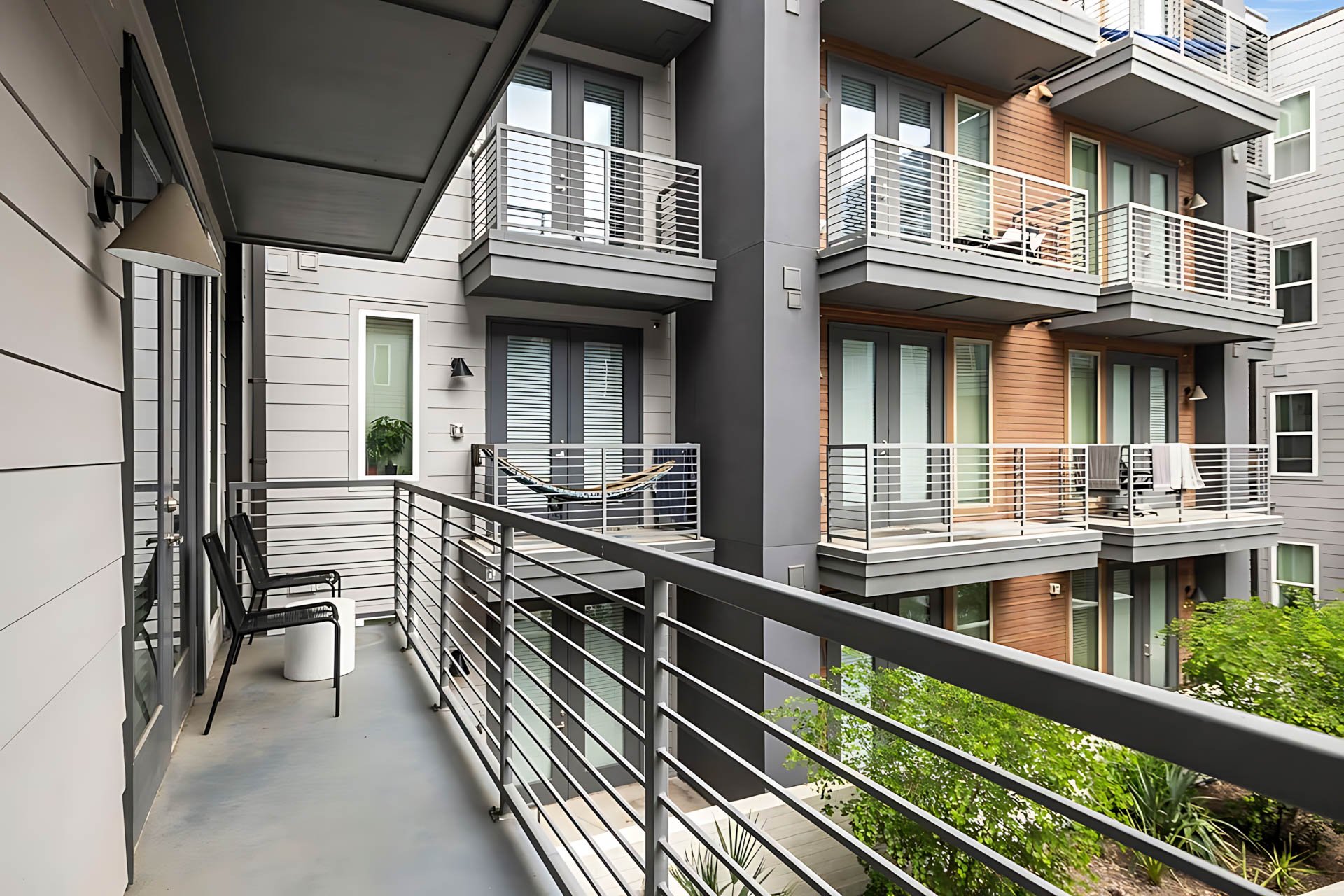 AUTX002_Guestroom_Premium Two Bedroom Apartment_Outside View_Balcony with chairs railing