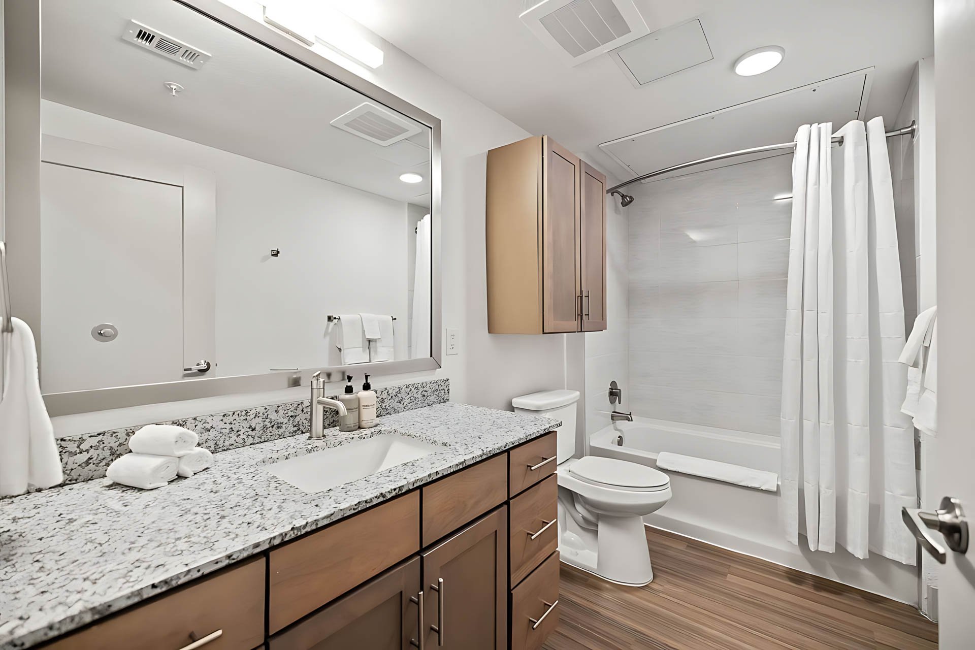 AUTX002_Guestroom_Studio Apartment_Bathroom_Granite countertop wooden cabinets