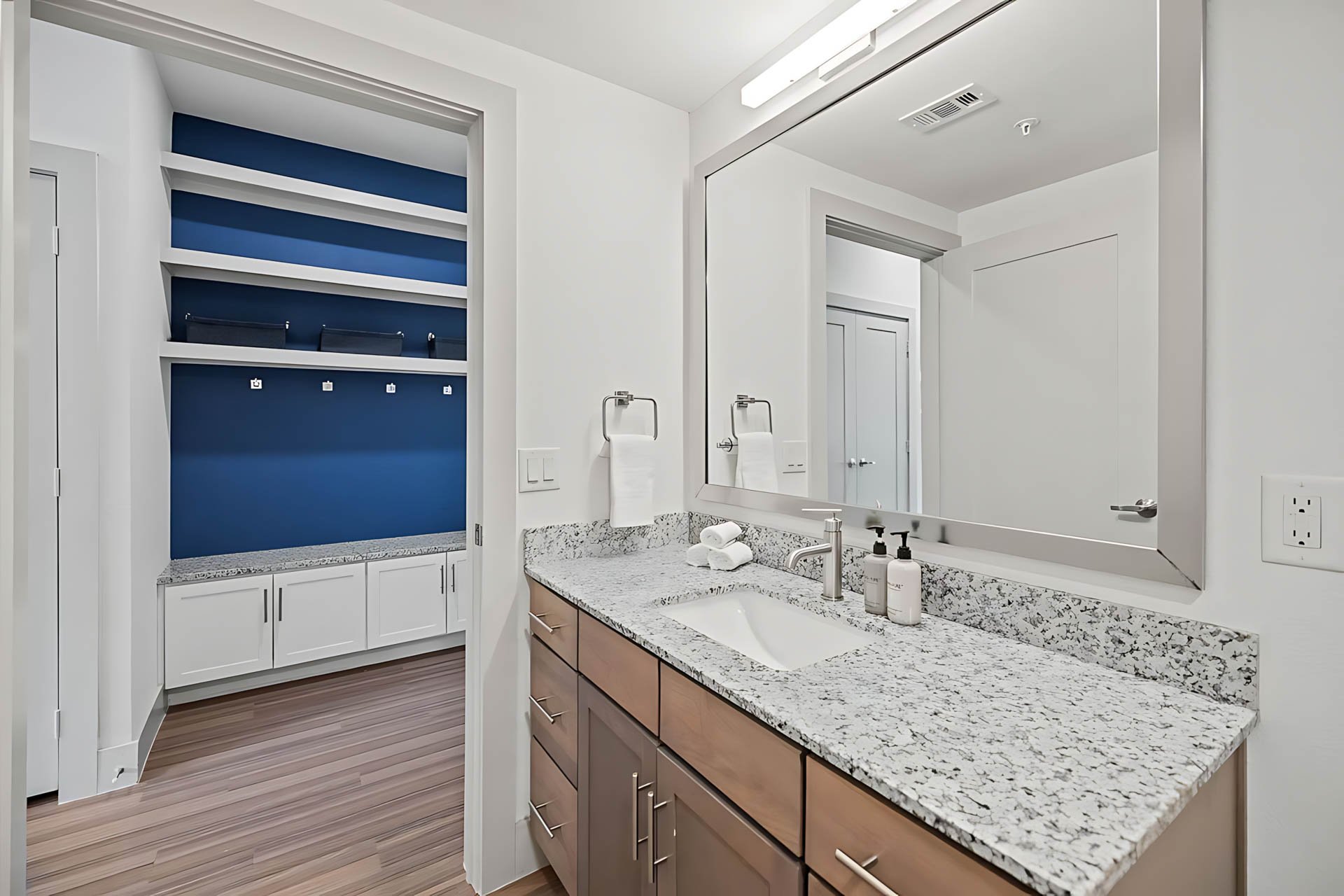 AUTX002_Guestroom_Studio Apartment_Bathroom_Granite vanity blue shelves