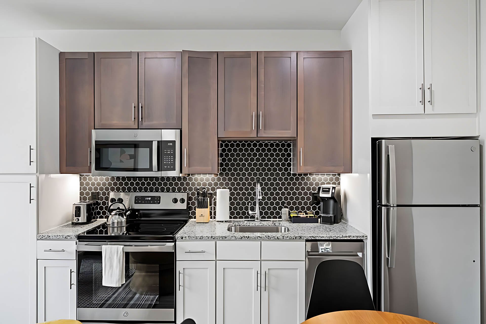 AUTX002_Guestroom_Two-story Two Bedroom Apartment_Kitchen_Dark wood cabinets granite countertop