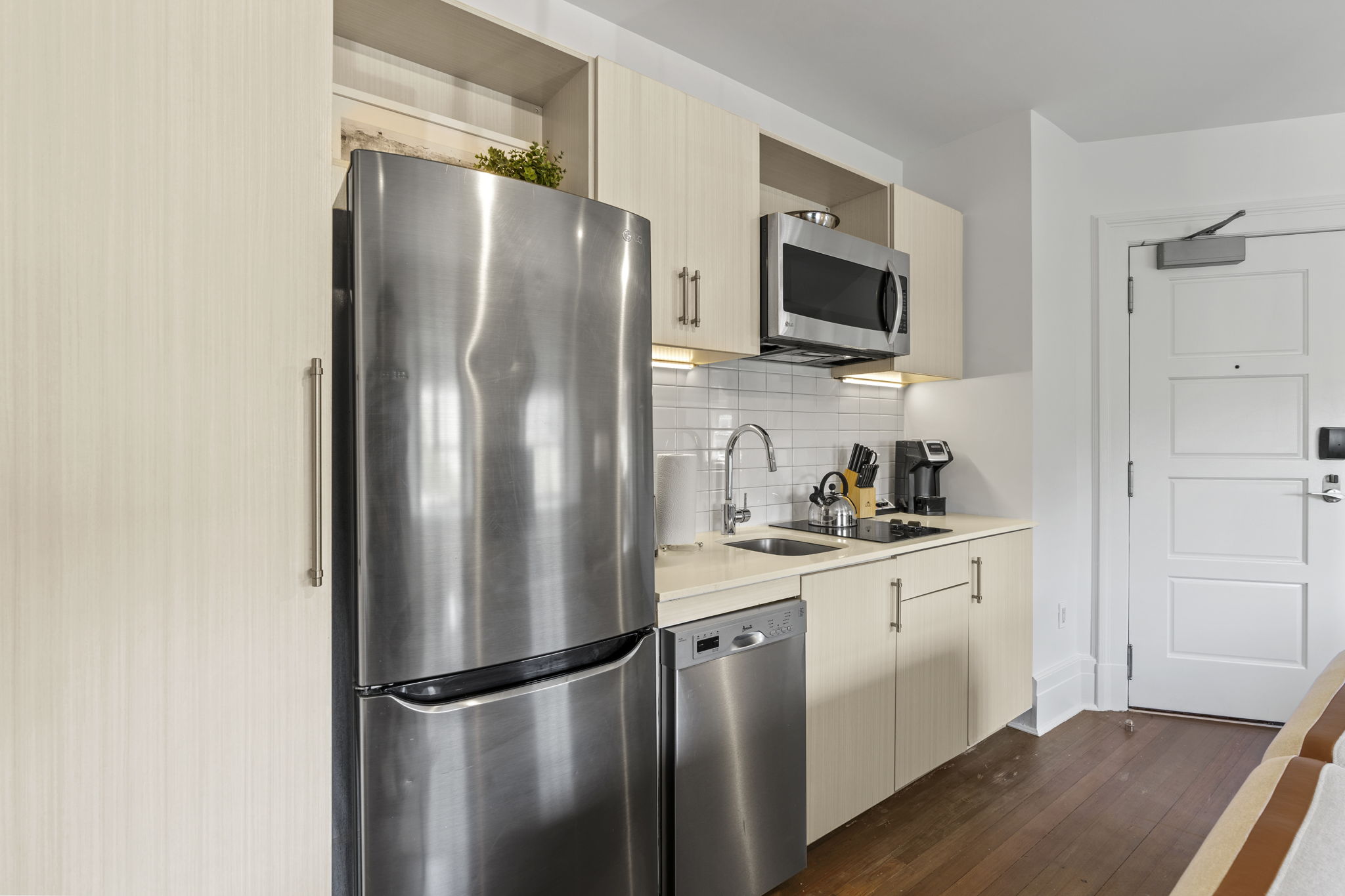 Kitchenette with full fridge and stovetop.