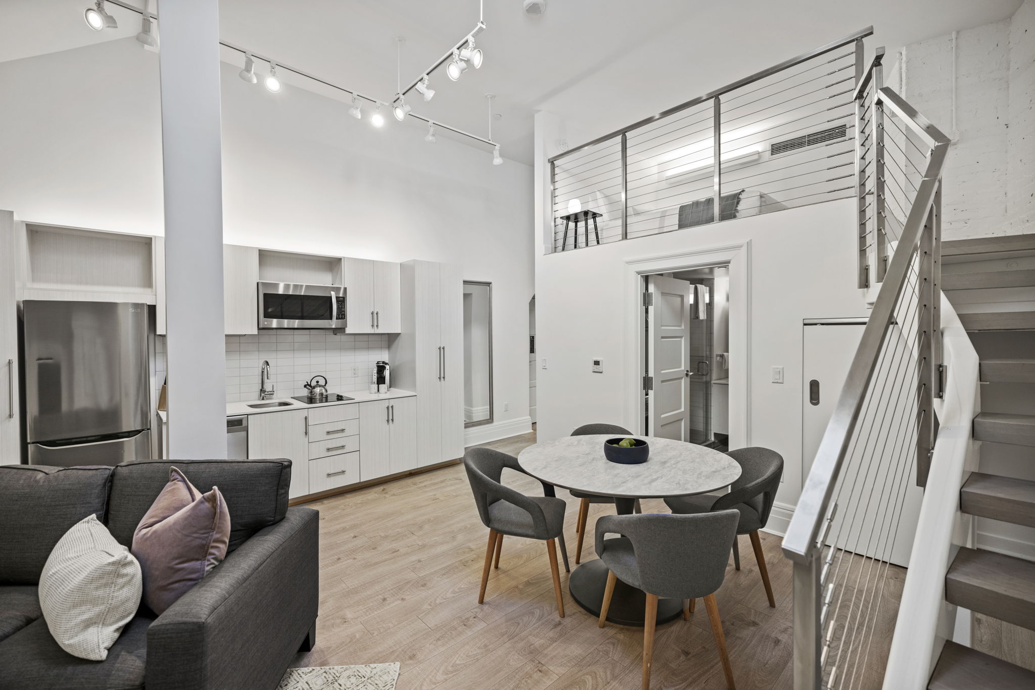 Living room, kitchenette, dining area, and lofted bedroom