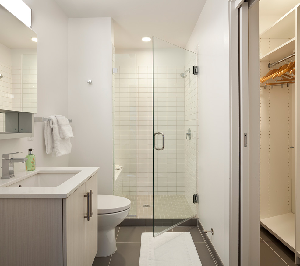 Bathroom with walk in shower and closet