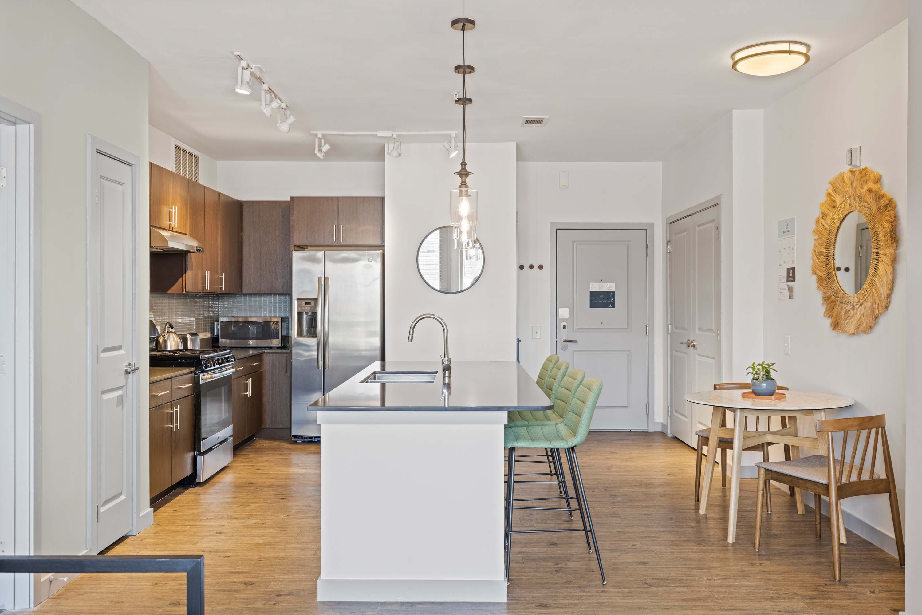 Full kitchen with breakfast bar and dining area.