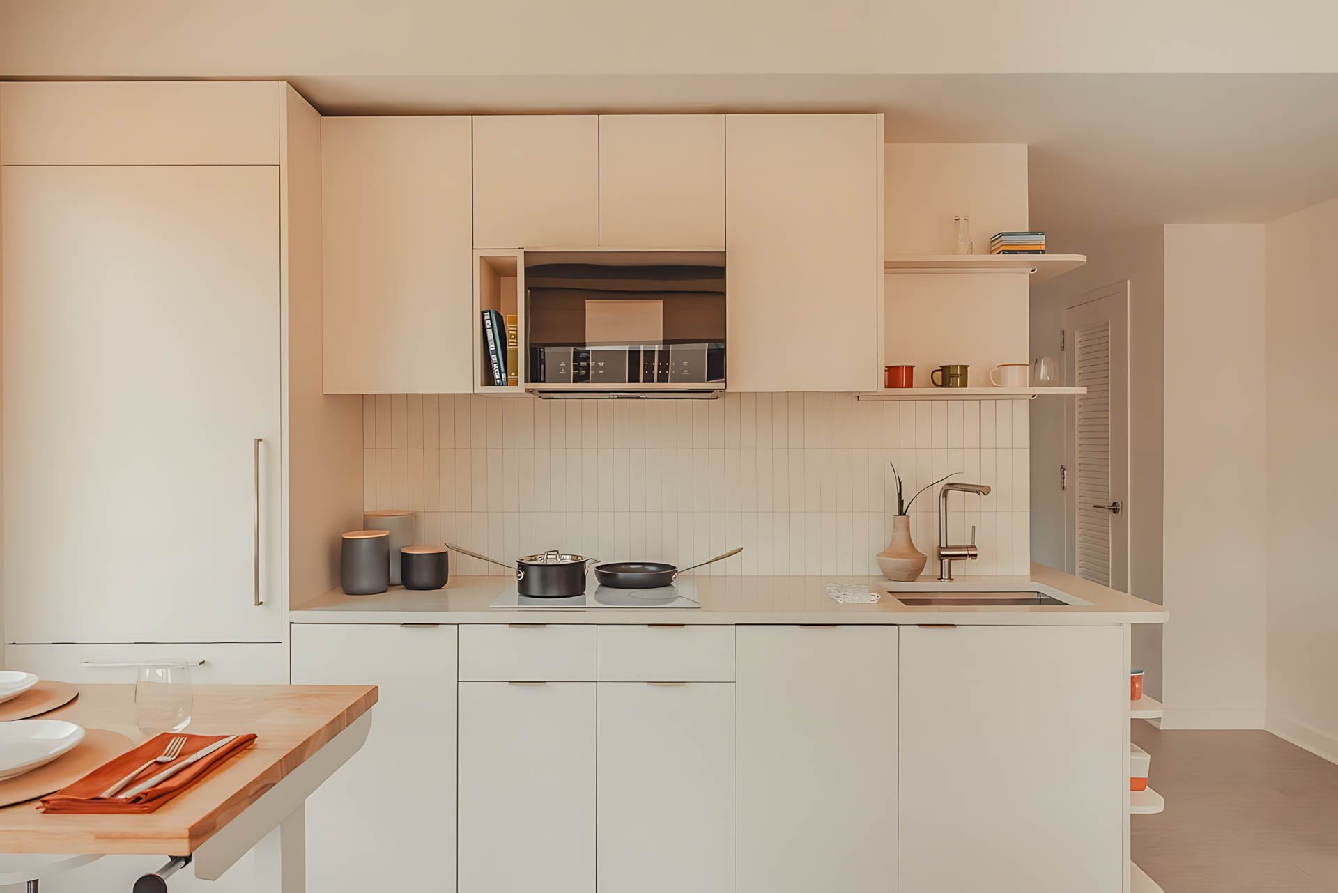 ATGA001_Guestroom_Premium Two Bedroom_Kitchen_White kitchen cabinetry stovetop