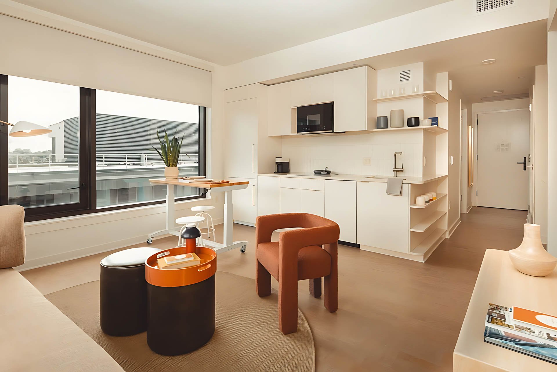 ATGA001_Guestroom_Premium Two Bedroom_Lounge Area_Orange armchair black tables