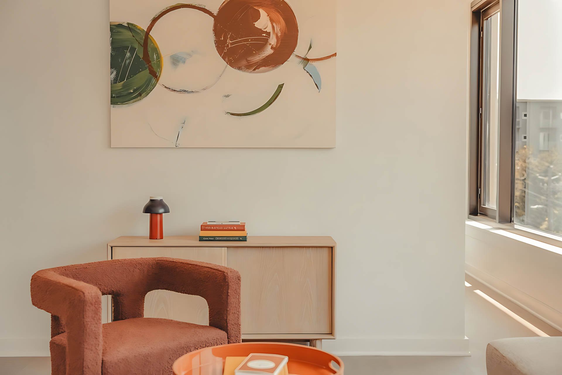 ATGA001_Guestroom_Two Bedroom_Lounge Area_Orange armchair wooden sideboard