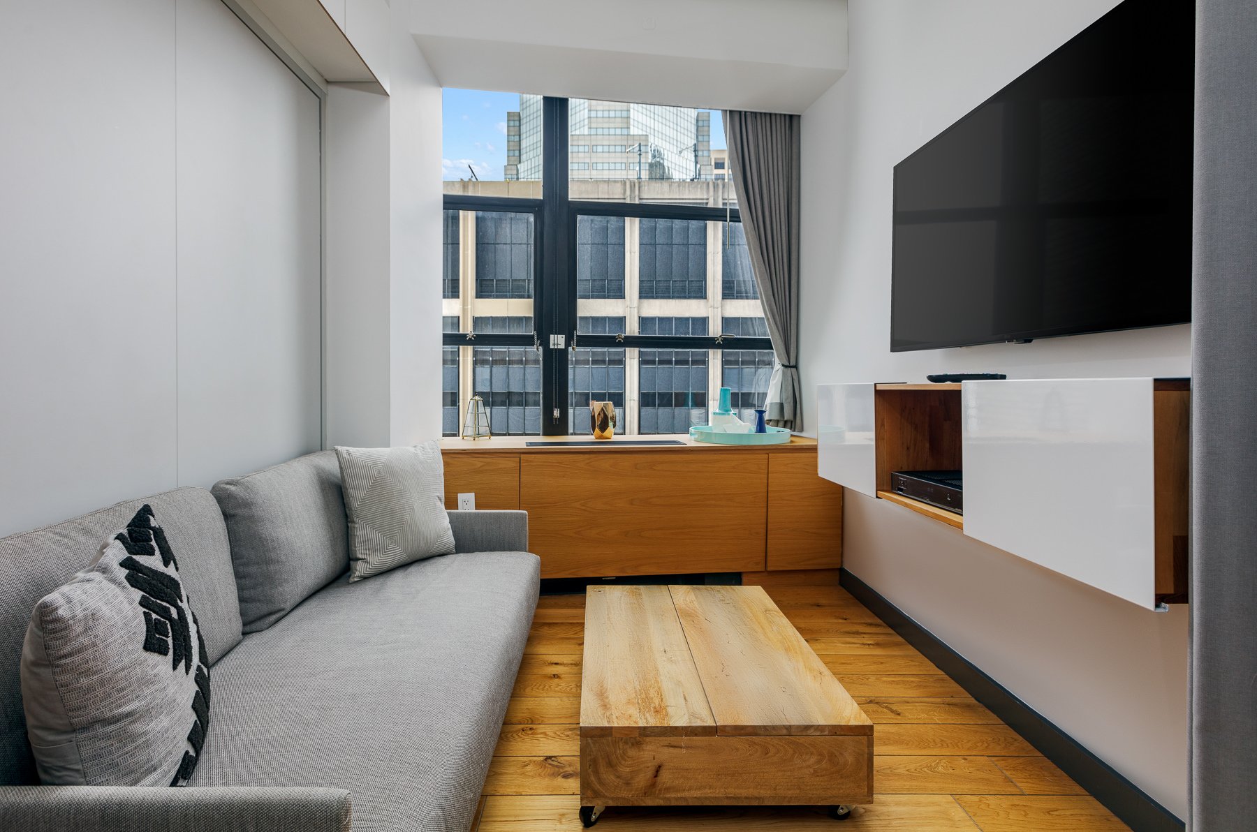 Living area with television and city views.