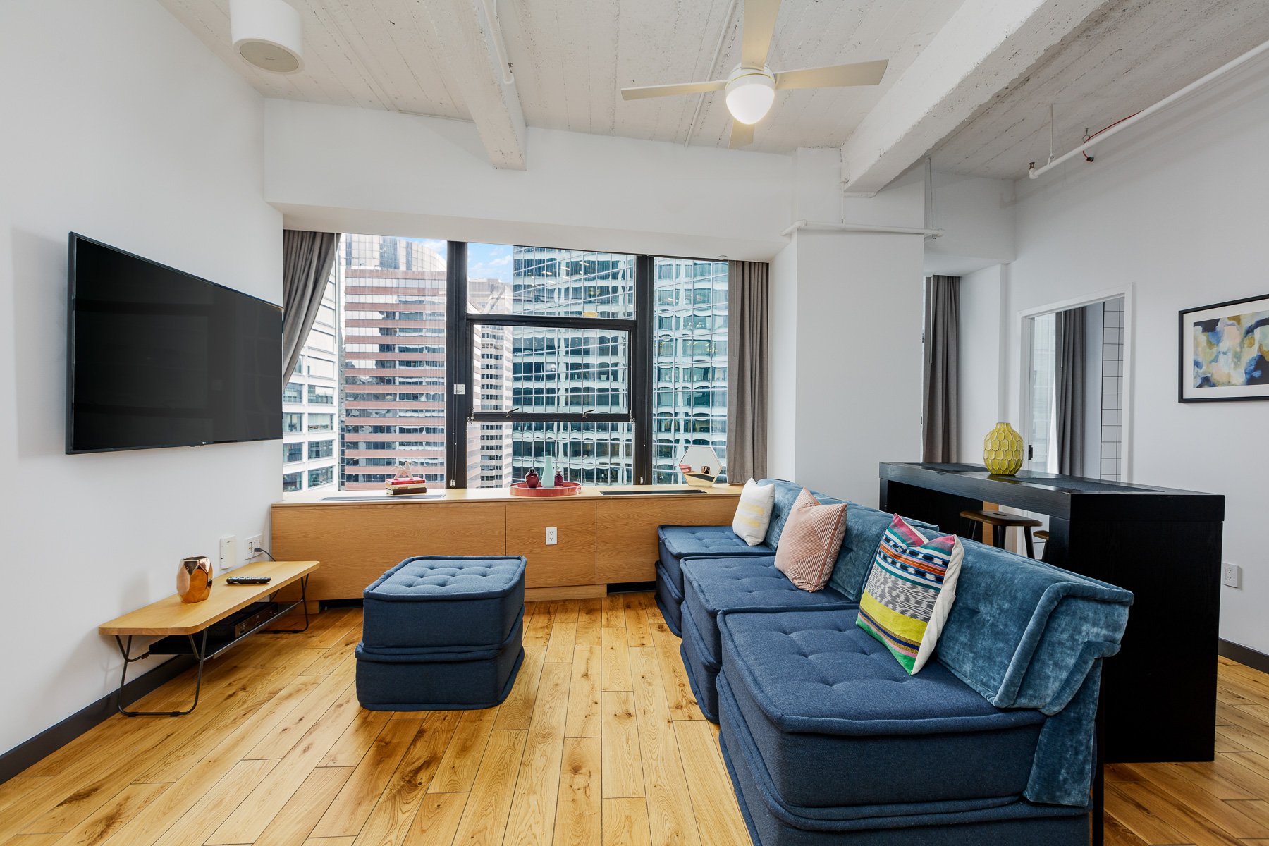 Living space with television and city views. 