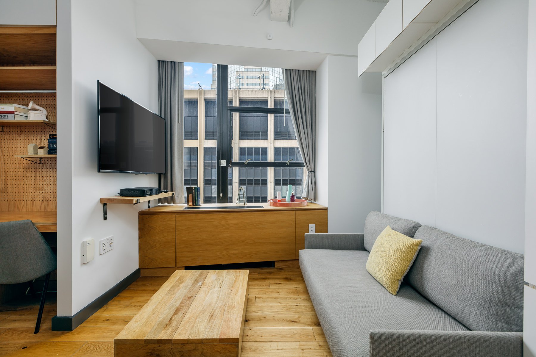Living space with television and city views.