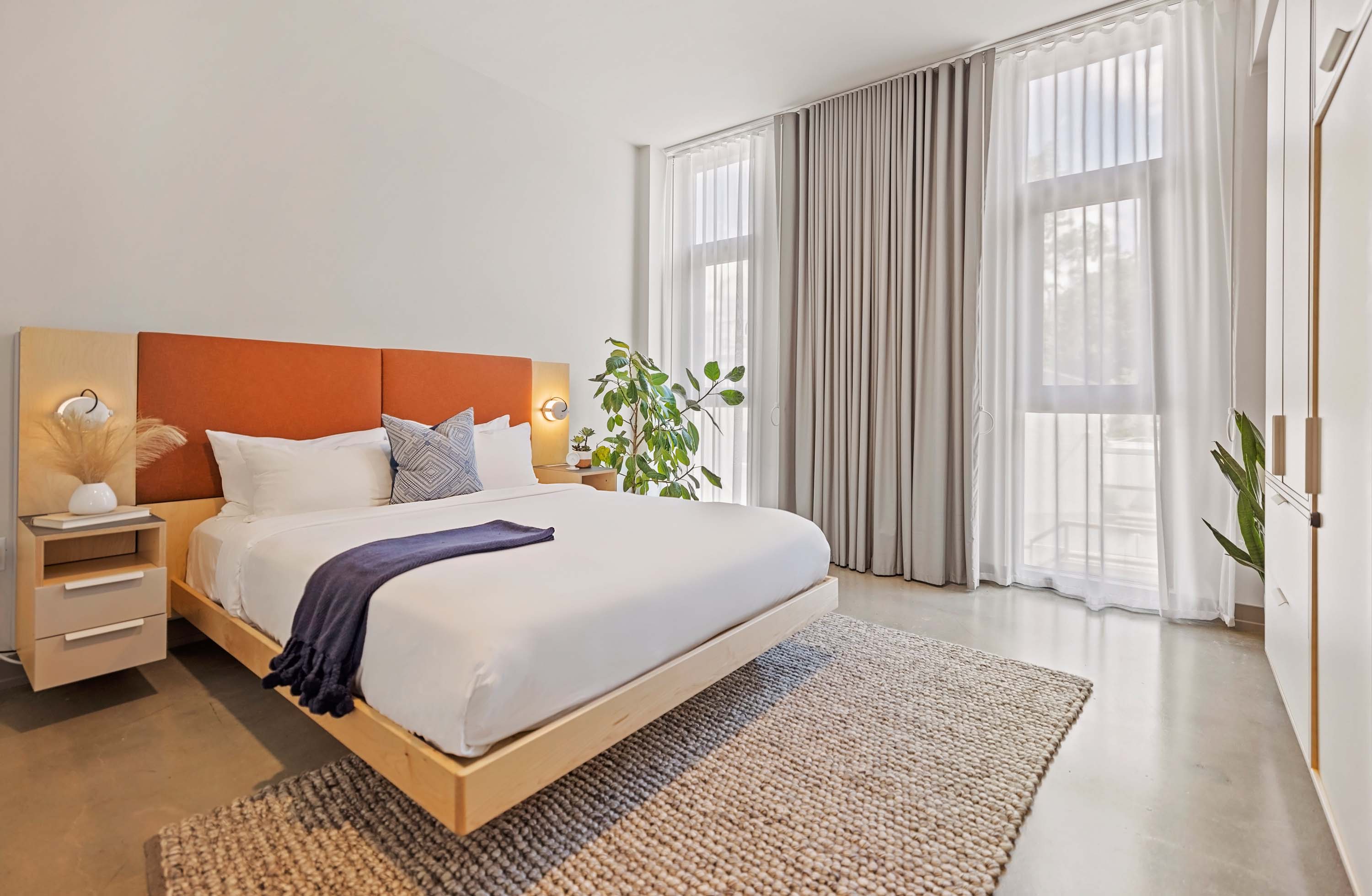 Bedroom with queen bed and natural light. 